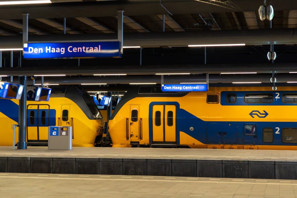 pexels-photo-32023909 Bright yellow Dutch trains at Den Haag Centraal on a quiet platform.